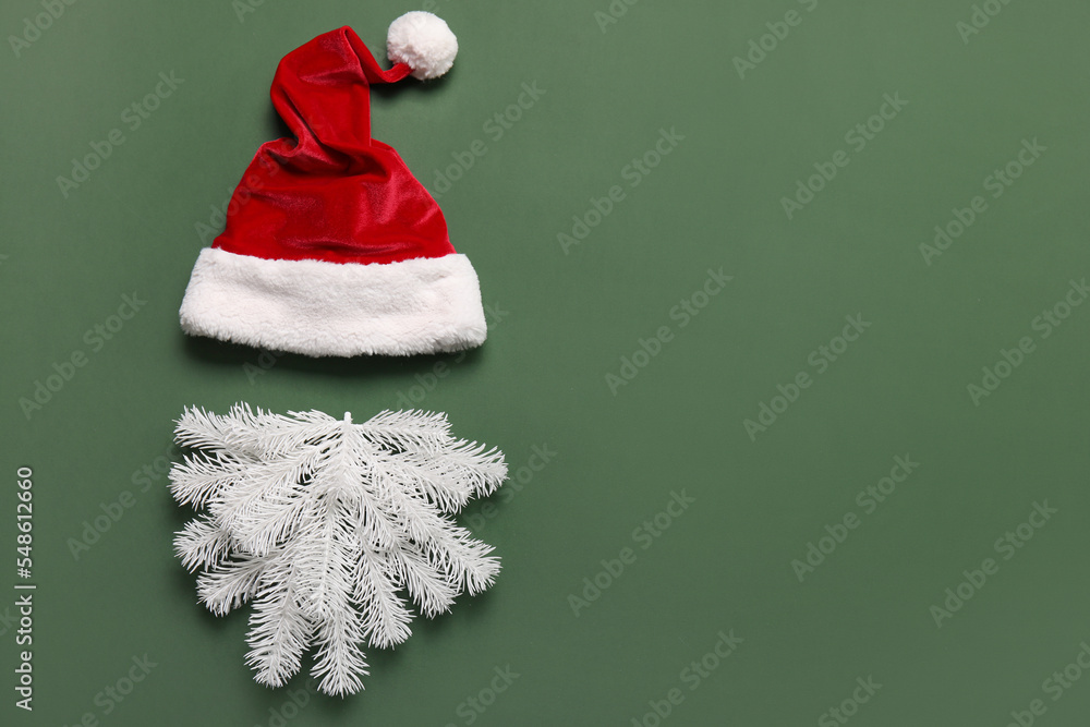 Santa hat and beard made of white fir branches on green background