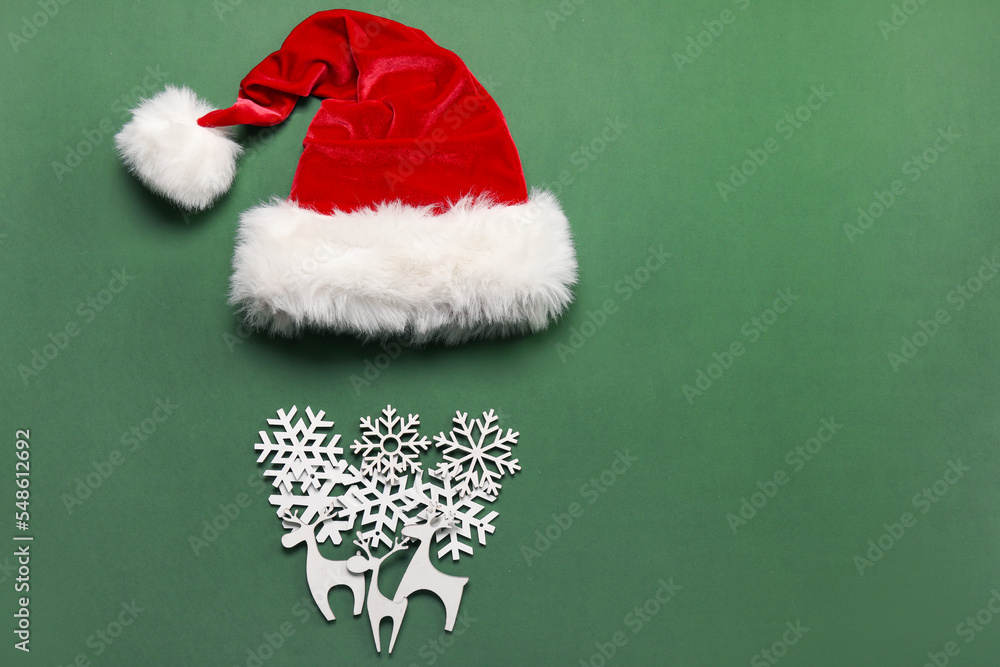 Santa hat and beard made of wooden Christmas decor on green background