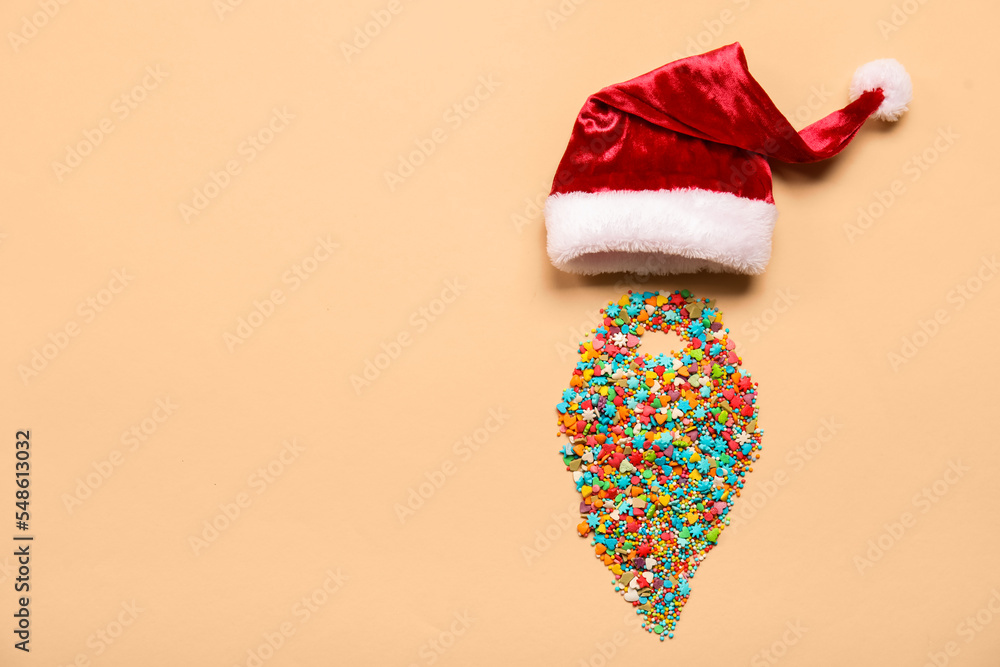 Santa hat and beard made of colorful sprinkles on color background