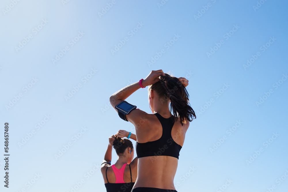 Fitness women, blue sky background and hair tie for cardio exercise, running workout and summer well