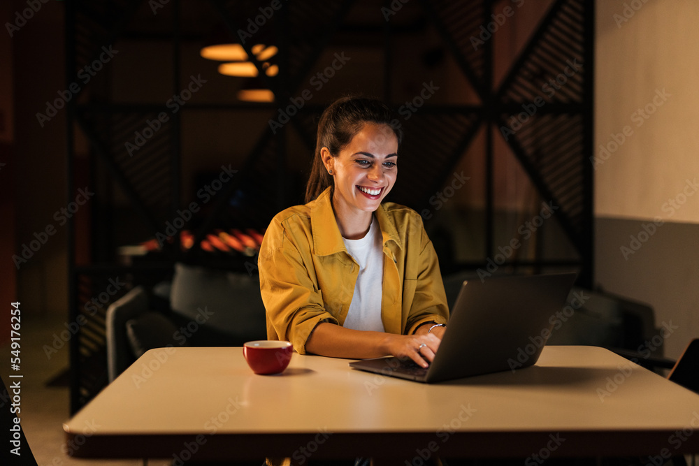 Smiling businesswoman working online, over the laptop, doing networking.