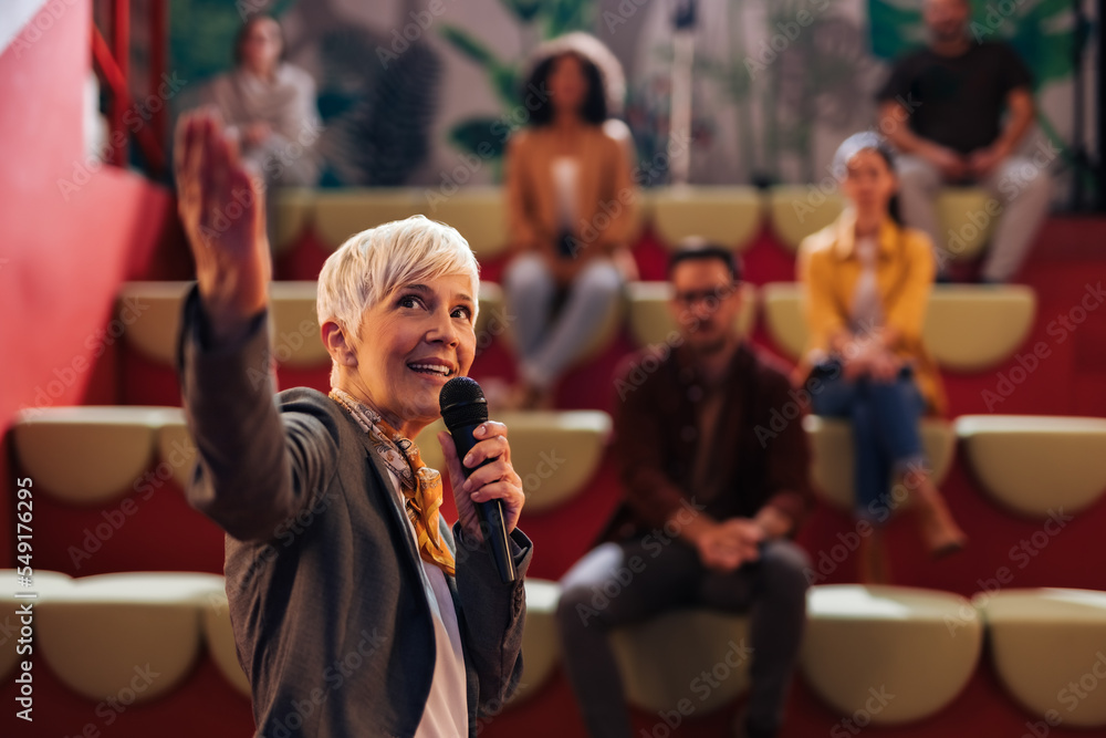 Businesswoman showing the presentation to the people in the public, learning something new.