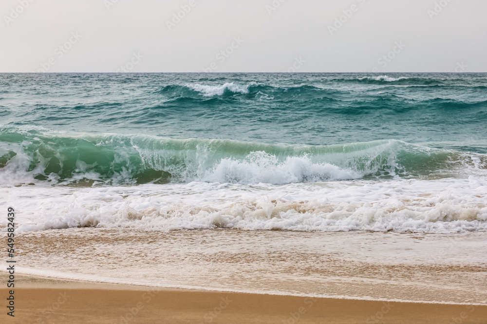 View of beautiful sea with waves on cloudy day