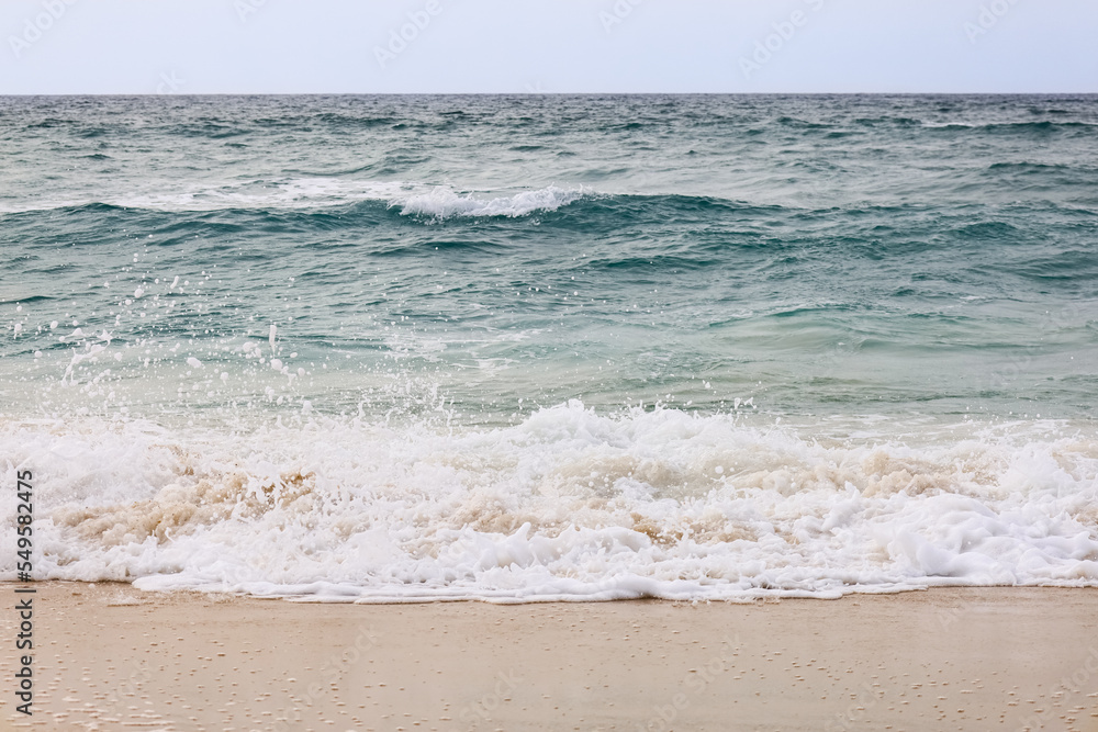 View of beautiful sea with waves on cloudy day