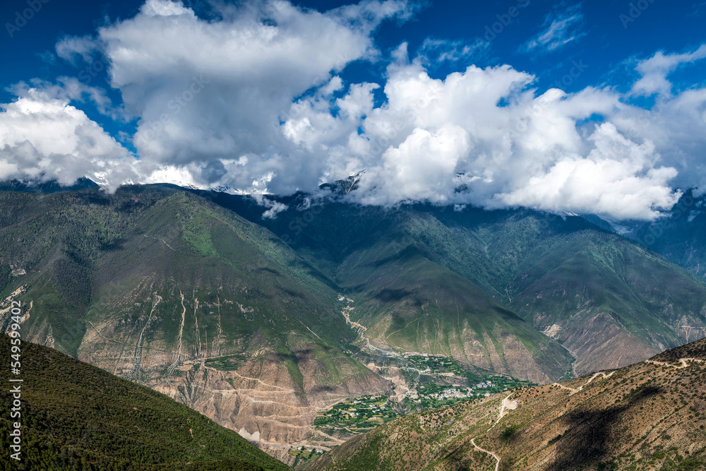 Meri snow mountain and town landscape in Deqen prefecture Yunnan province, China.	 