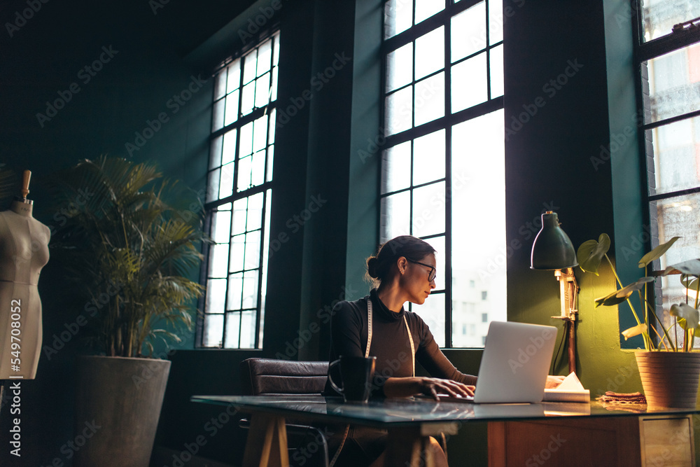 Female fashion designer working in her office