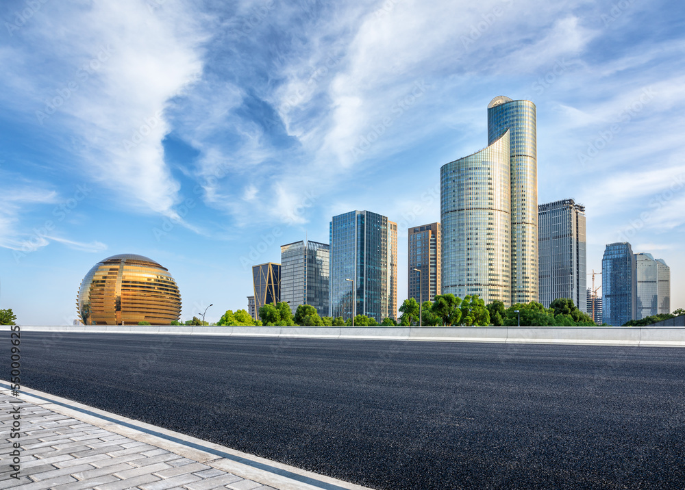 Asphalt highway and city skyline with modern buildings scenery in Hangzhou, China.