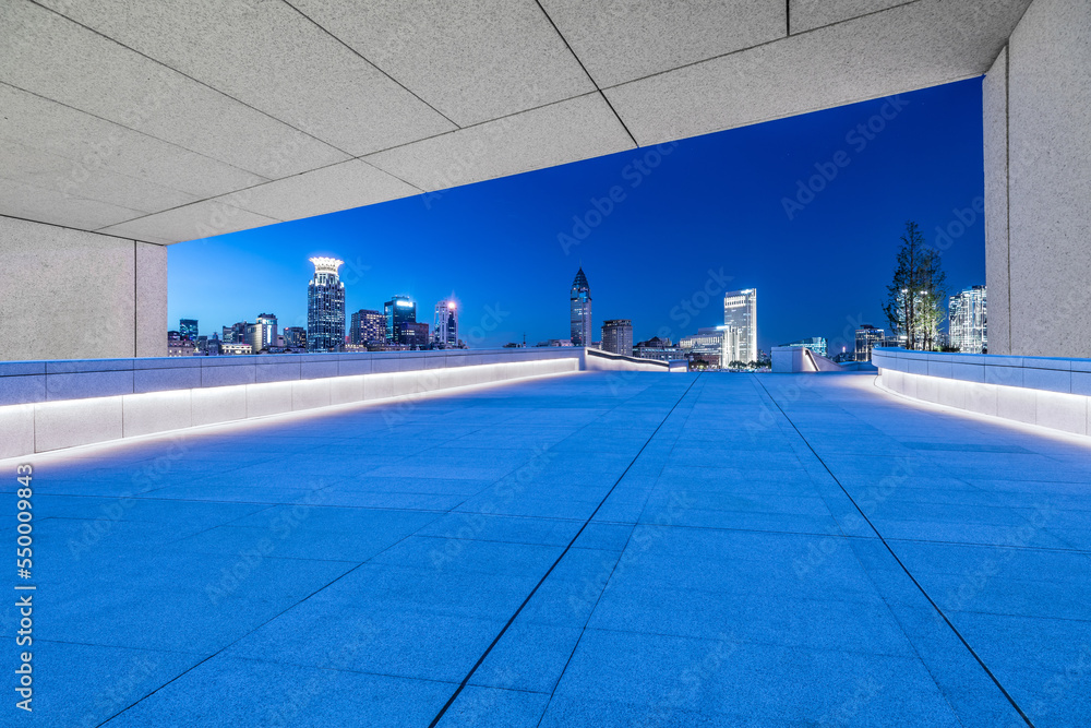 empty square floor and city skyline with modern buildings in Shanghai at night, China. 