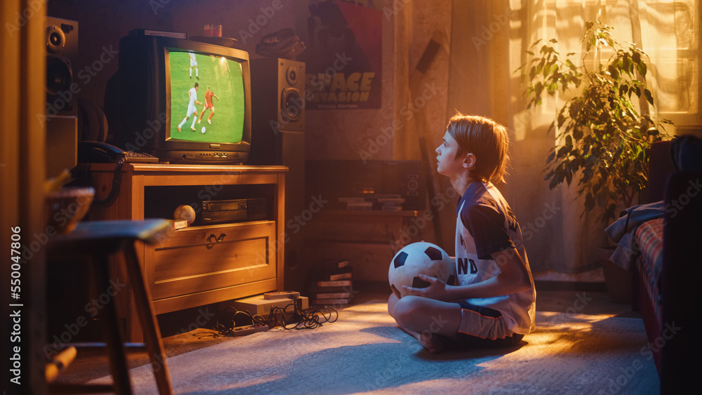 Young Excited Sports Fan Watches a Soccer Match on TV at Home. Curious Boy Supporting His Favorite F