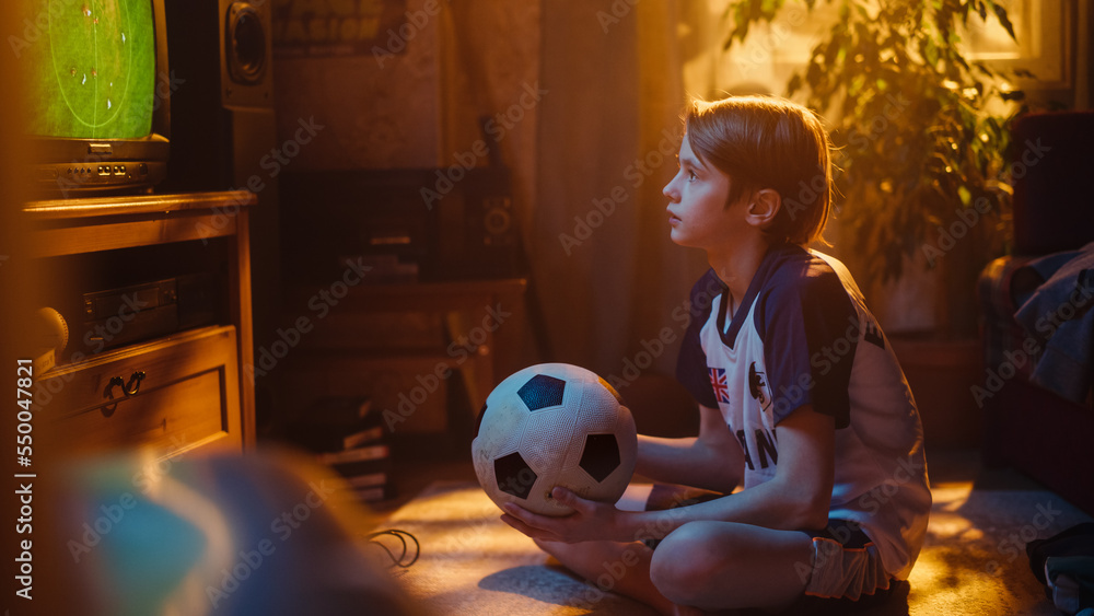 Young Excited Sports Fan Watches a Soccer Match on TV at Home. Boy Supporting His Favorite Football 