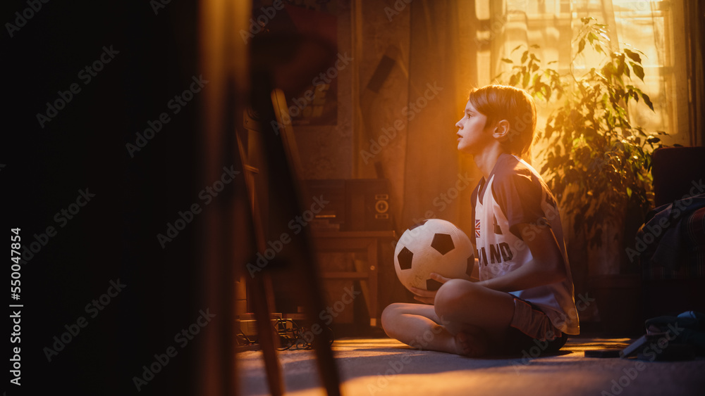 Portrait of a Young Soccer Fan Watching a Cup Match on TV set at Home. Handsome Boy Supporting His F