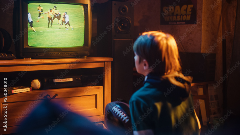 Young Sports Fan Watches American Football Match on TV at Home. Handsome Boy Supporting His Favorite