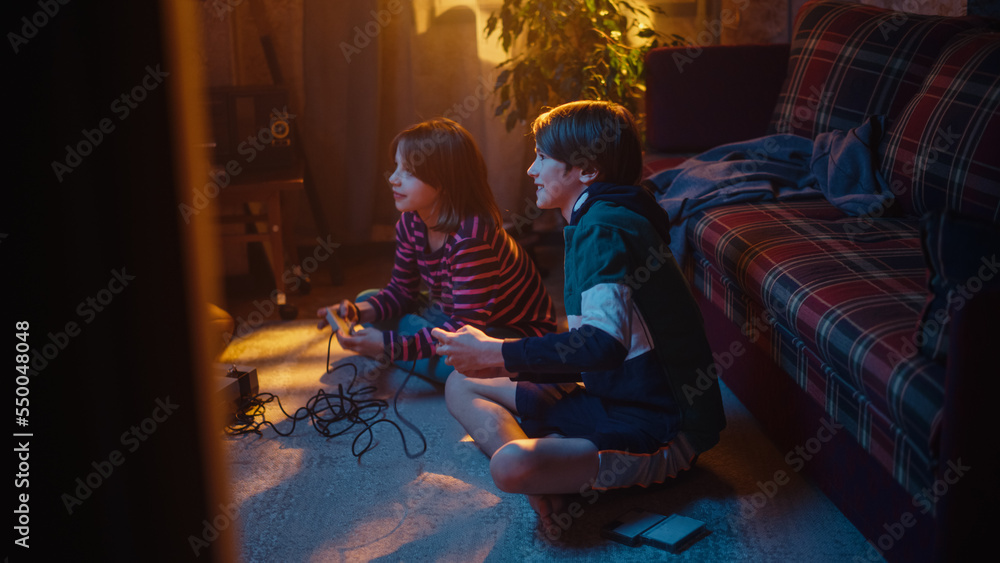 Nostalgic Childhood Concept. Young Brother and Sister Playing Old-School Arcade Video Game on a Retr