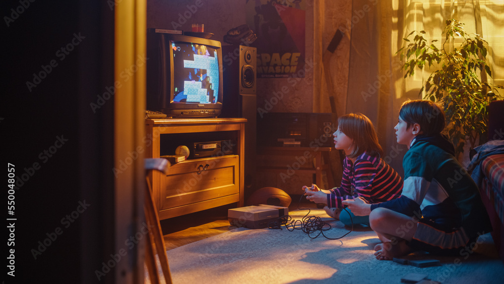 Nostalgic Childhood Concept: Young Brother and Sister Playing 8 Bit 2D Arcade Video Game on a Retro 