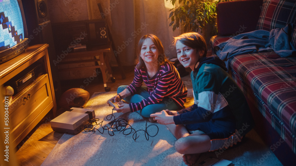 Home Video Concept: Young Brother and Sister Playing Old-School Arcade Video Game on a Retro TV Set 