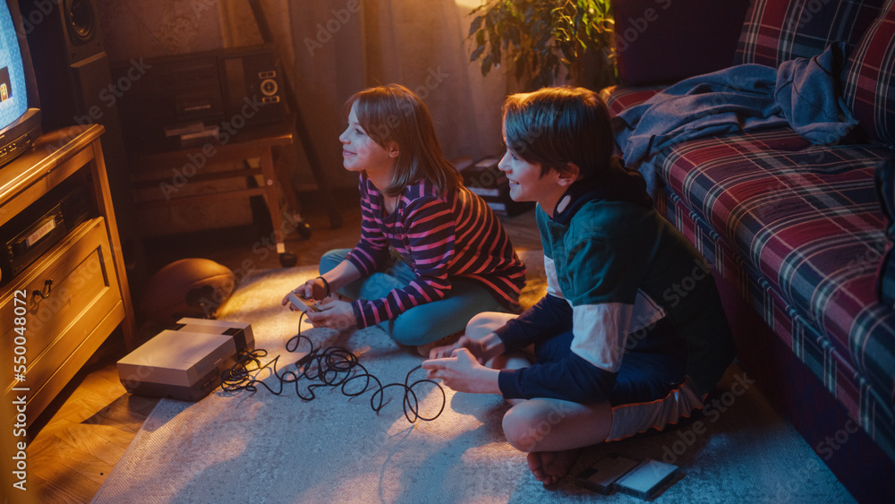 Nostalgic Childhood Concept: Young Brother and Sister Playing Vintage 8 Bit 2D Arcade Video Game on 