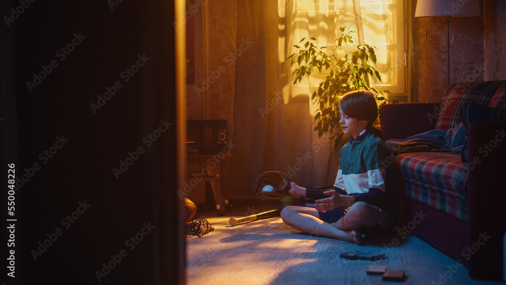 Young Sports Fan Playing with Baseball Ball and Glove at Home in Living Room with Dated Interior. Ha