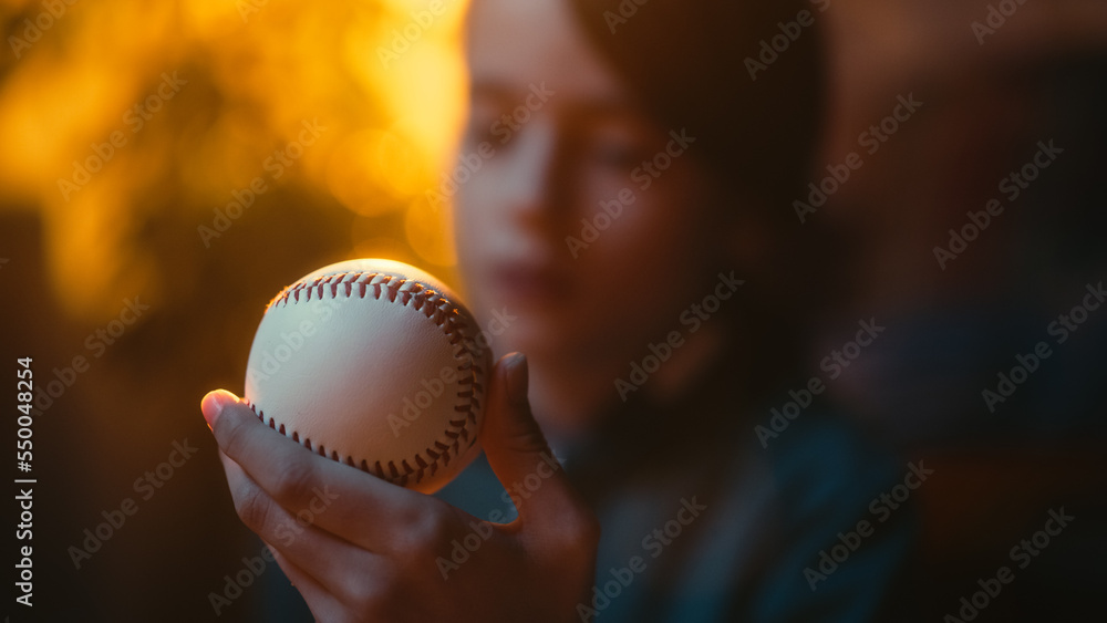 Close Up Portrait of a Young Sports Fan Holding a White Baseball Ball at Home. Excited Boy Looking a