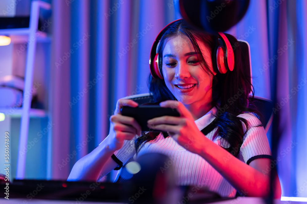 Asian young beautiful woman playing mobile game on smartphone at home. 