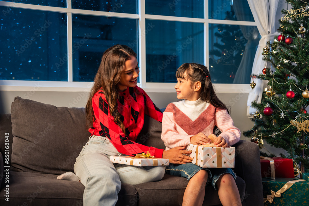 Caucasian family exchanging presents during Christmas party at home.