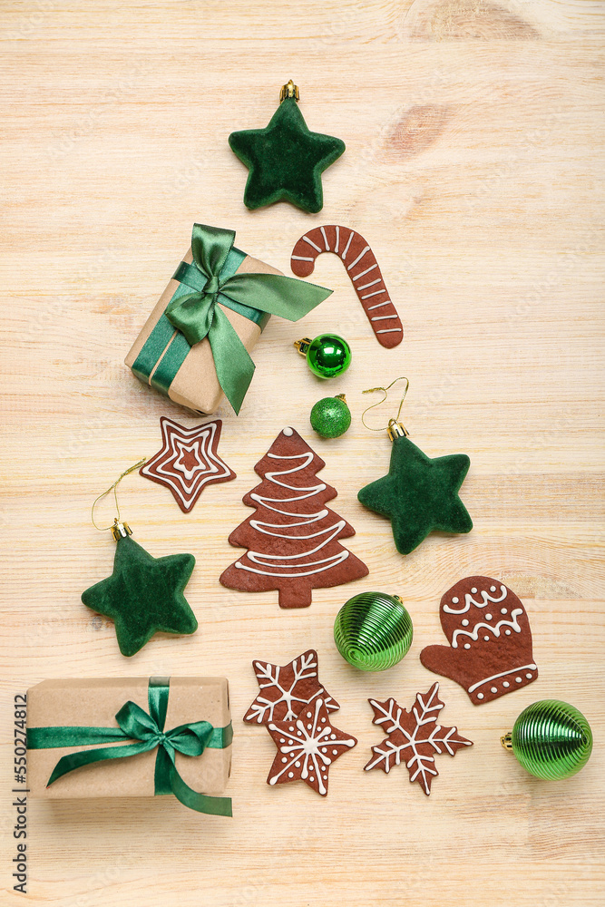 Christmas tree made of decorations, cookies and gifts on wooden background