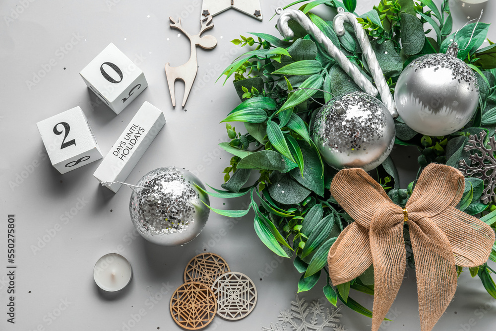 Stylish Christmas wreath, calendar and decorations on white background, closeup