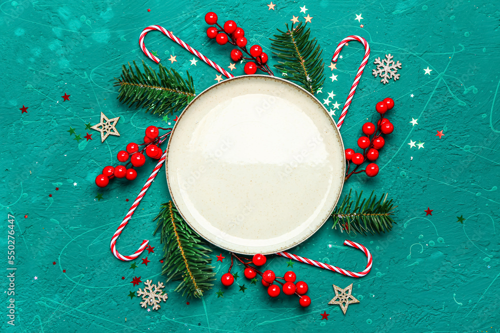 Composition with empty plate and beautiful Christmas decorations on color background