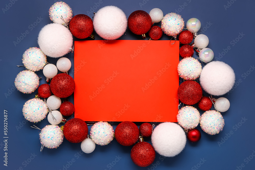 Composition with blank card and Christmas balls on blue background