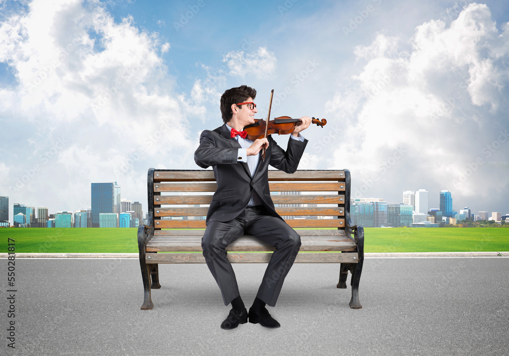 Young businessman plays the violin