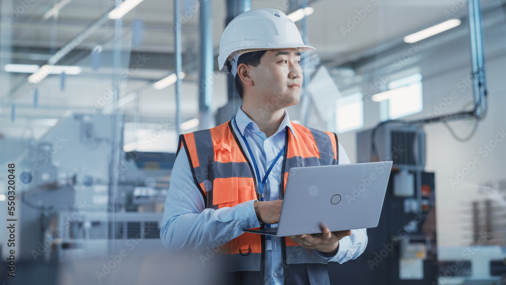 Portrait of an Asian Male Engineer in Orange Safety Vest Working on Laptop Computer at Electronic Ma