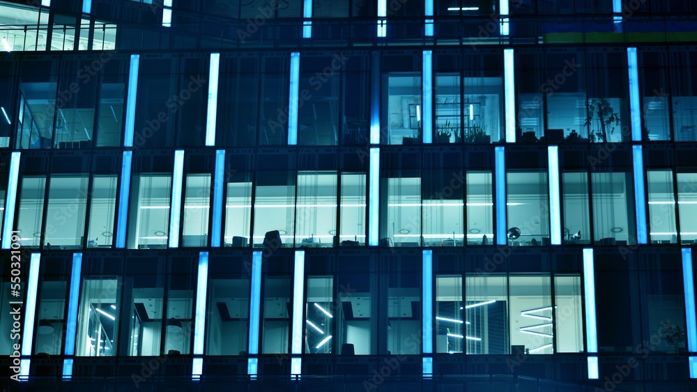 Pattern of office buildings windows illuminated at night. Glass architecture ,corporate building at 