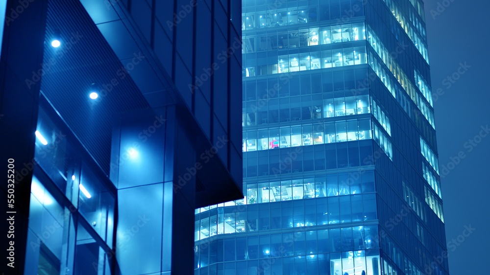 Pattern of office buildings windows illuminated at night. Glass architecture ,corporate building at 