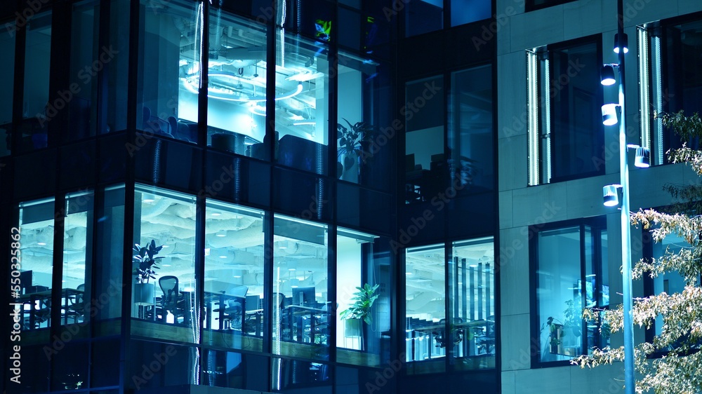 Pattern of office buildings windows illuminated at night. Glass architecture ,corporate building at 