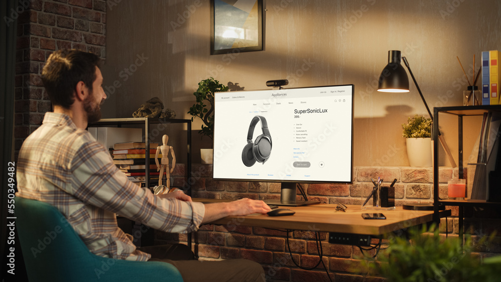 Portrait of a Handsome Bearded Young Adult Man in Casual Clothes Using Desktop Computer in Stylish L