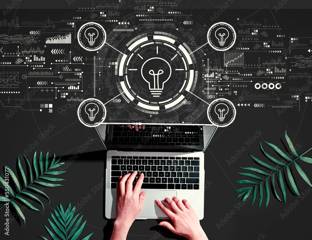 Idea light bulb theme with person using a laptop computer