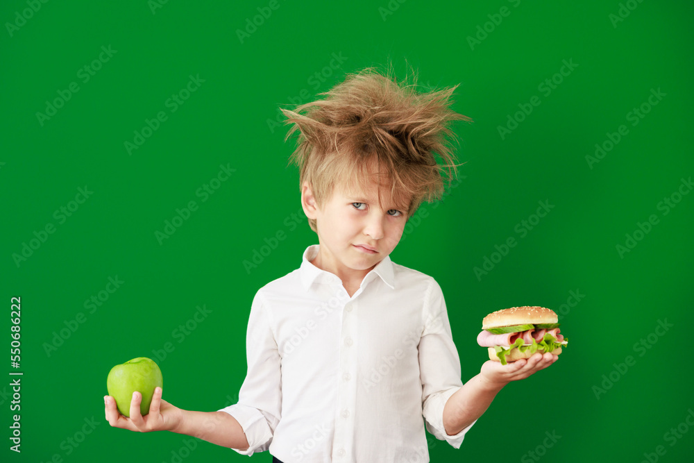 Surprised child against green chalkboard in class