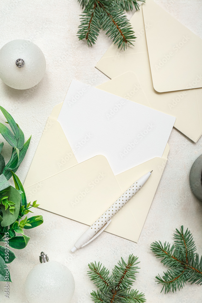 Envelopes with blank card, Christmas branches and balls on white background