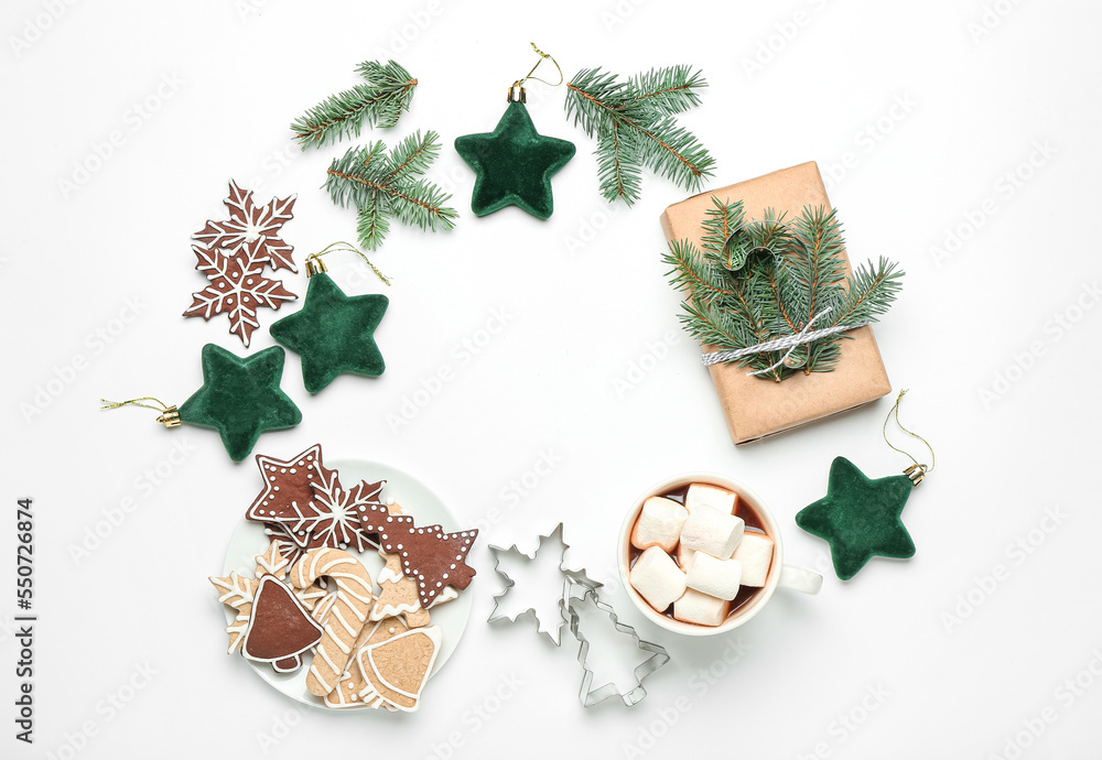 Frame made of Christmas decor, cookies, cocoa and gift on white background