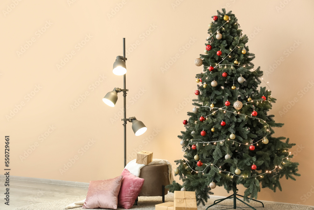 Interior of living room with Christmas tree, glowing lamp and presents