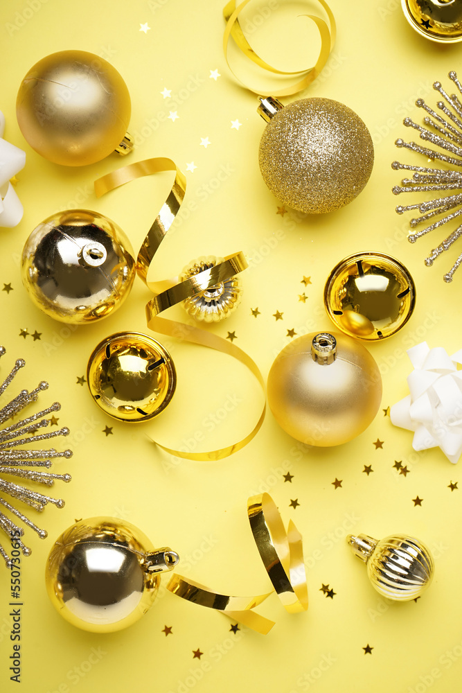 Shiny Christmas decorations on yellow background