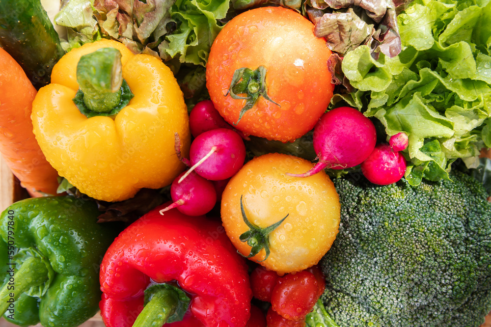 Wooden crate filled with fresh organic vegetables .