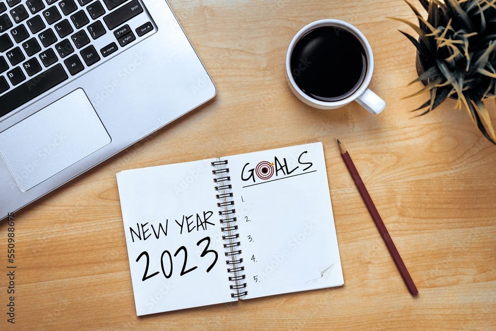 2023 Happy New Year Resolution Goal List and Plans Setting - Business office desk with notebook writ