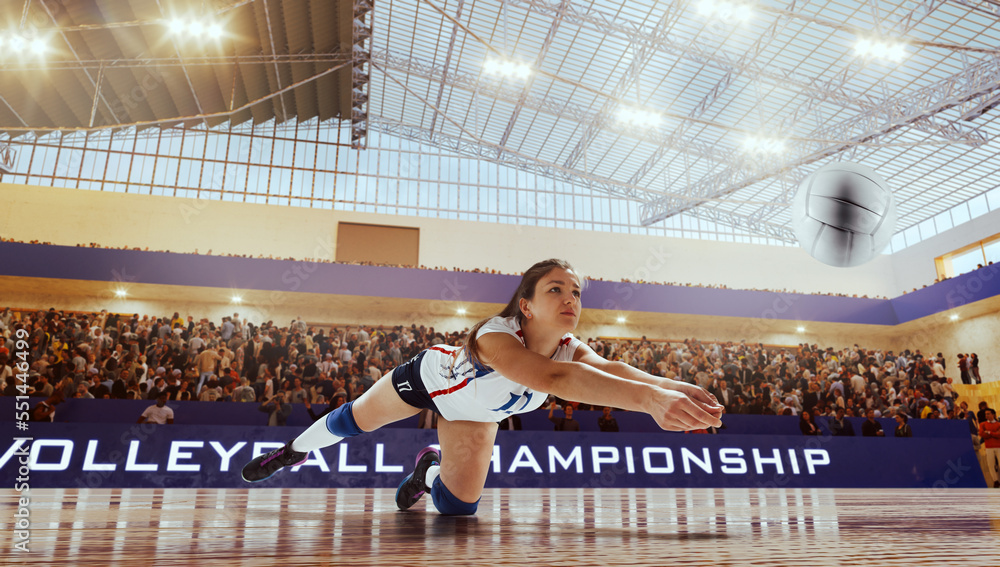 Female volleyball players in action on professional stadium. 