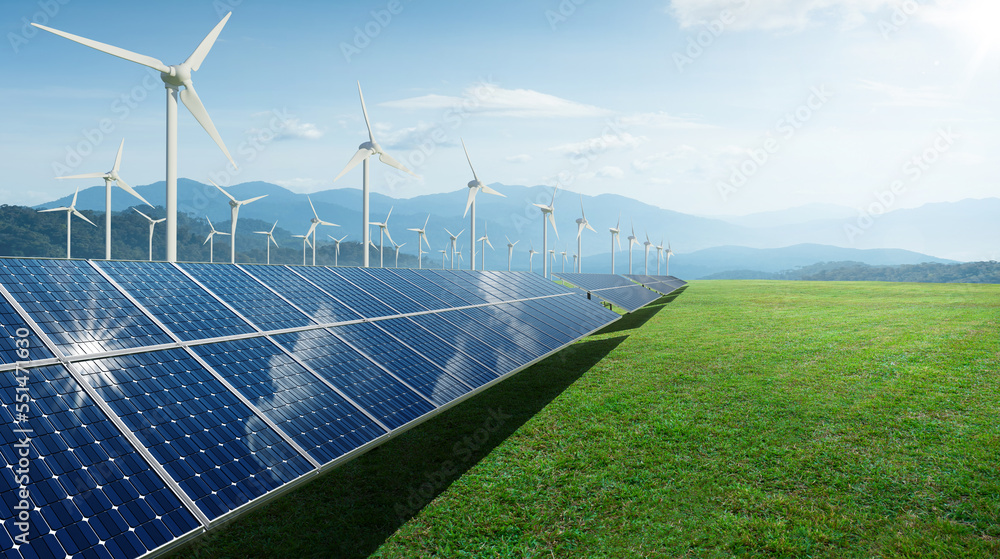 Solar panels and wind generators under blue sky