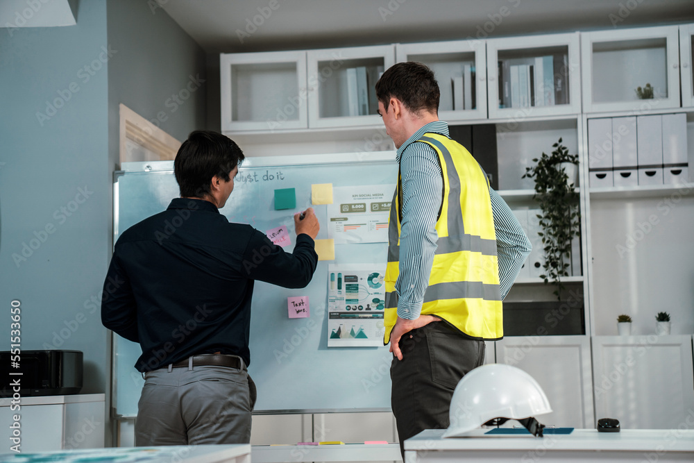 A pair of competent investor and engineer brainstorming on the whiteboard to find new ideas and maki