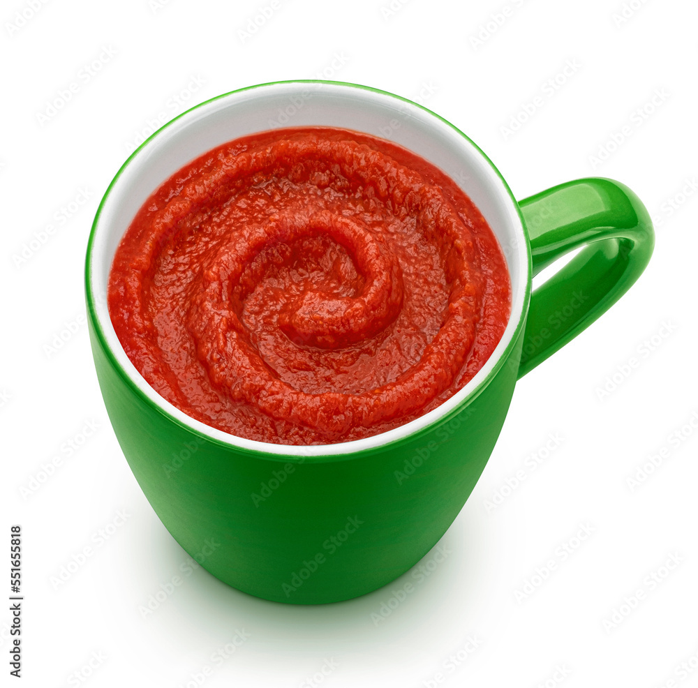 Tomato soup in green mug isolated on white background, top view