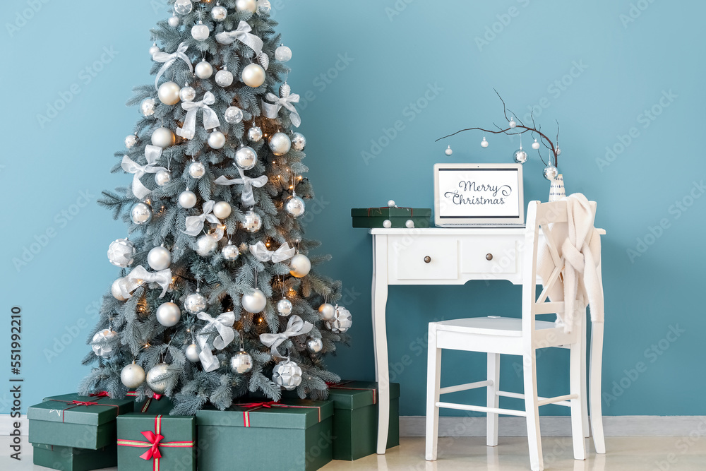 Interior of office with workplace and Christmas tree