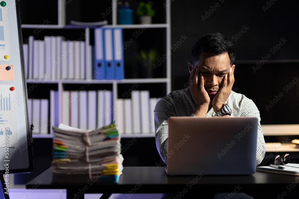 Business people in the night office working overtime are stressed by overwork and worrying about dea