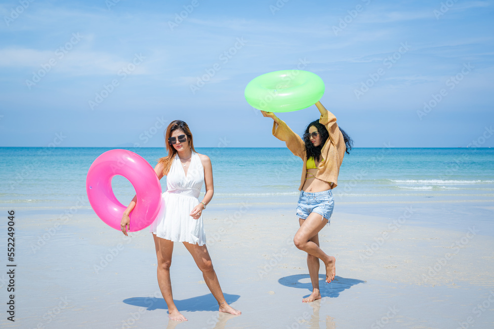 People spending time at the beautiful beach,Happy female friends enjoy activity on holiday travel va