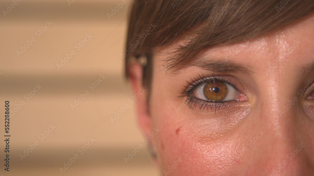 CLOSE UP, PORTRAIT: A detailed shot of young womans beautiful brown eye